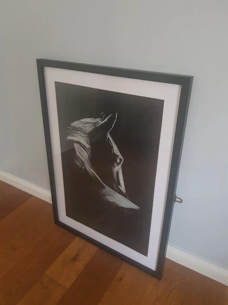 A framed picture of a black and white horse portrait drawing.