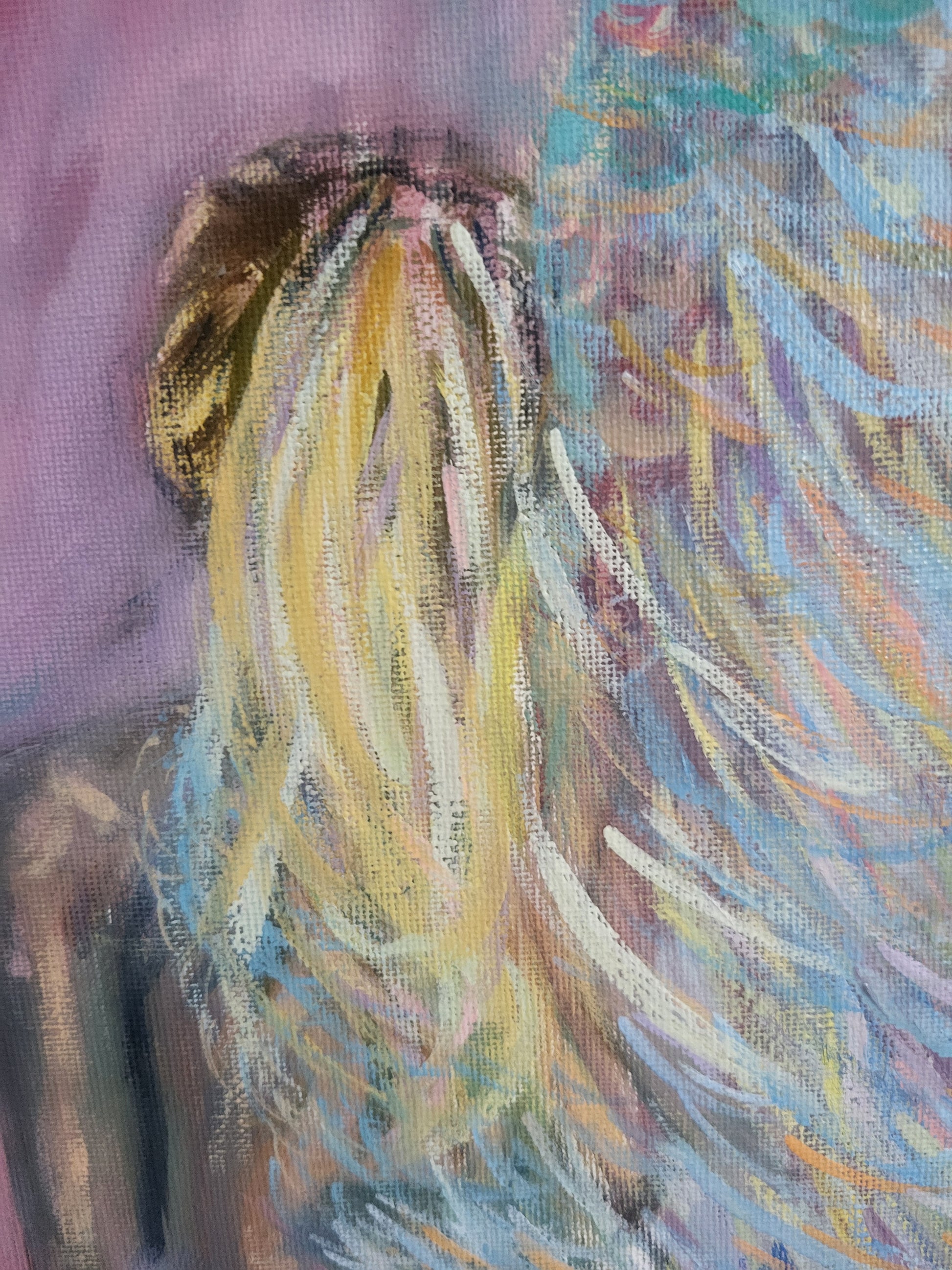 Picture of multicoloured angel figure on a pink background.
